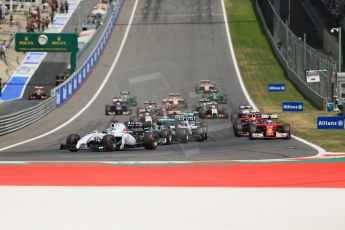 World © Octane Photographic Ltd. Sunday 22nd June 2014. Red Bull Ring, Spielberg - Austria - Formula 1 Race. The Williams Martini Racing FW36 of Felipe Massa leads the pack away on the opening lap as Rosberg's Mercedes dives past Bottas. Digital Ref: 1000LB1D5033