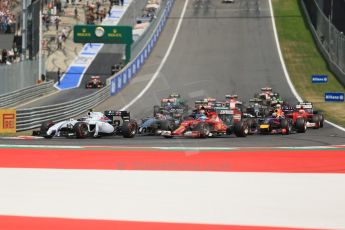 World © Octane Photographic Ltd. Sunday 22nd June 2014. Red Bull Ring, Spielberg - Austria - Formula 1 Race. Scuderia Ferrari F14T - Fernando Alonso (Ferrari) and Kevin Magnussen (McLaren) pressure Bottas for 3rd on turn 1 of lap 1. Digital Ref: 1000LB1D5040