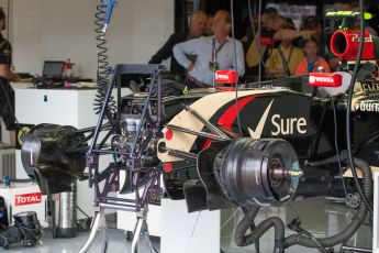 World © Octane Photographic Ltd. Friday 4th July 2014. British GP - Silverstone, UK. - Formula 1 Practice 2. Lotus F1 Team E22 front brakes and suspension – Pastor Maldonado's car in the garage with Jonathan Palmer in the background. Digital Ref: 1013JM1D0001
