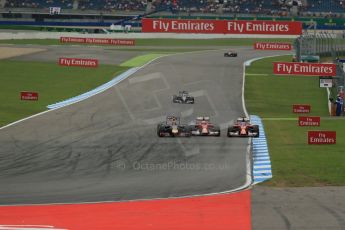 World © Octane Photographic Ltd. Sunday 20th July 2014. German GP, Hockenheim. Formula 1 Race. Infiniti Red Bull Racing RB10 - Sebastian Vettel andScuderia Ferrari F14T - Fernando Alonso and Kimi Raikkonen who is just about to loose a front wing endplate. Digital Ref: