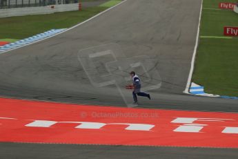 World © Octane Photographic Ltd. Sunday 20th July 2014. German GP, Hockenheim. - Formula 1 Race. A marshal collects Kimi Raikkonen's Ferrari F14T front wing endplate from the track. Digital Ref: