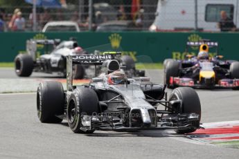World © Octane Photographic Ltd. Sunday 7th September 2014, Italian GP, Monza - Italy. - Formula 1 Race. McLaren Mercedes MP4/29 – Kevin Magnussen and Jenson Button sandwich the Infiniti Red Bull Racing RB10 of Sebastian Vettel. Digital Ref: 1112LB1D6150