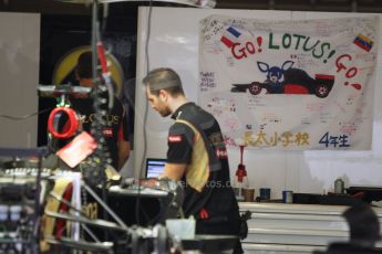 World © Octane Photographic Ltd. Thursday 2nd October 2014, Japanese Grand Prix - Suzuka. - Formula 1 Pitlane. Lotus F1 Team E22 – Pastor Maldonado flag by Elementary school fans. Digital Ref: 1129CB1D2242