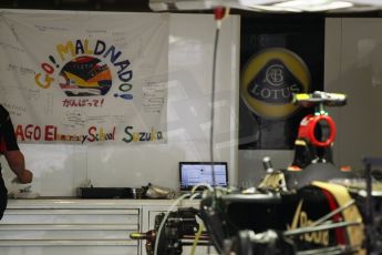 World © Octane Photographic Ltd. Thursday 2nd October 2014, Japanese Grand Prix - Suzuka. - Formula 1 Pitlane. Lotus F1 Team E22 – Pastor Maldonado flag by Elementary school fans. Digital Ref: 1129CB1D2244