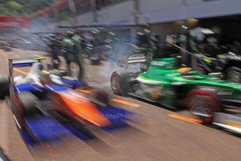 World © Octane Photographic Ltd. Friday 23rd May 2014. GP2 Feature Race – Monaco, Monte Carlo. Rio Haryanto - EQ8 Caterham Racing and Johnny Cecotto - Trident come close on the pit release. Digital Ref : 0963CB7D5332