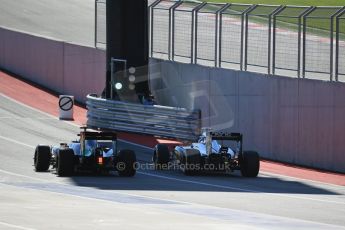 World © Octane Photographic Ltd. Saturday 1st November 2014, F1 USA GP, Austin, Texas, Circuit of the Americas (COTA) - Practice 3. Lotus F1 Team E22 - Romain Grosjean passing McLaren Mercedes MP4/29 – Kevin Magnussen in the pit lane Digital Ref: 1147LB1D9821