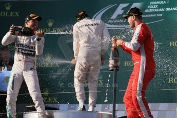 World © Octane Photographic Ltd. Mercedes AMG Petronas F1 W06 Hybrid – Lewis Hamilton (1st), Nico Rosberg (2nd) and Scuderia Ferrari SF15-T– Sebastian Vettel (3rd). Sunday 15th March 2015, F1 Australian GP Podium, Melbourne, Albert Park, Australia. Digital Ref: 1210LB1D0413