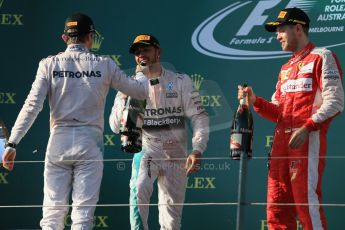 World © Octane Photographic Ltd. Mercedes AMG Petronas F1 W06 Hybrid – Lewis Hamilton (1st), Nico Rosberg (2nd) and Scuderia Ferrari SF15-T– Sebastian Vettel (3rd). Sunday 15th March 2015, F1 Australian GP Podium, Melbourne, Albert Park, Australia. Digital Ref: 1210LB1D0572