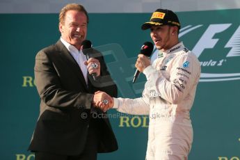 World © Octane Photographic Ltd. Mercedes AMG Petronas F1 W06 Hybrid – Lewis Hamilton (1st) with Arnold (Arnie) Schwarzenegger. Sunday 15th March 2015, F1 Australian GP Podium, Melbourne, Albert Park, Australia. Digital Ref: 1210LB1D0648