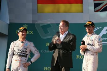World © Octane Photographic Ltd. Mercedes AMG Petronas F1 W06 Hybrid – Lewis Hamilton (1st) and Nico Rosberg (2nd) with Arnold (Arnie) Schwarzenegger. Sunday 15th March 2015, F1 Australian GP Podium, Melbourne, Albert Park, Australia. Digital Ref: 1210LB1D0662