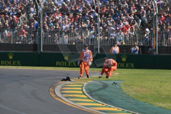 World © Octane Photographic Ltd. Track marshals clearing up after Maldonado's Lotus crash. Sunday 15th March 2015, F1 Australian GP Race, Melbourne, Albert Park, Australia. Digital Ref: 1209LB1D9463