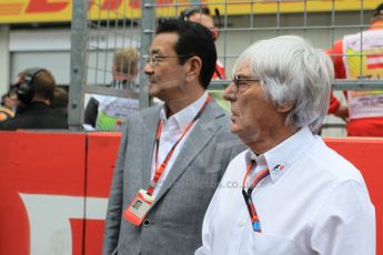 World © Octane Photographic Ltd. Honda chief executive Takahiro Hachigo and Bernie Ecclestone. Sunday 21st June 2015, F1 Austrian GP Grid, Red Bull Ring, Spielberg, Austria. Digital Ref: 1318LW1L3994