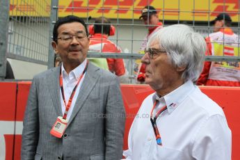 World © Octane Photographic Ltd. Honda chief executive Takahiro Hachigo and Bernie Ecclestone. Sunday 21st June 2015, F1 Austrian GP Grid, Red Bull Ring, Spielberg, Austria. Digital Ref: 1318LW1L4000