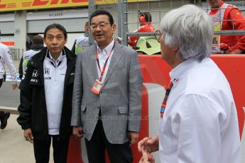 World © Octane Photographic Ltd. Honda chief executive Takahiro Hachigo and Bernie Ecclestone. Sunday 21st June 2015, F1 Austrian GP Grid, Red Bull Ring, Spielberg, Austria. Digital Ref: 1318LW1L4013b