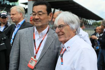 World © Octane Photographic Ltd. Honda chief executive Takahiro Hachigo and Bernie Ecclestone. Sunday 21st June 2015, F1 Austrian GP Grid, Red Bull Ring, Spielberg, Austria. Digital Ref: 1318LW1L4062