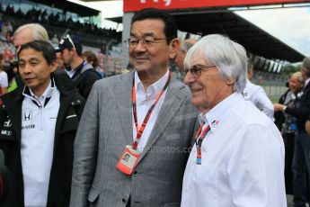 World © Octane Photographic Ltd. Honda chief executive Takahiro Hachigo and Bernie Ecclestone. Sunday 21st June 2015, F1 Austrian GP Grid, Red Bull Ring, Spielberg, Austria. Digital Ref: 1318LW1L4064