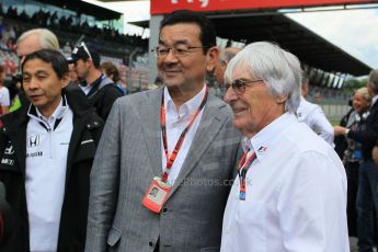 World © Octane Photographic Ltd. Honda chief executive Takahiro Hachigo and Bernie Ecclestone. Sunday 21st June 2015, F1 Austrian GP Grid, Red Bull Ring, Spielberg, Austria. Digital Ref: 1318LW1L4064