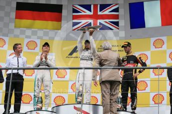 World © Octane Photographic Ltd. Mercedes AMG Petronas F1 W06 Hybrid – Lewis Hamilton (1st), Nico Rosberg (2nd) and Lotus F1 Team E23 Hybrid – Romain Grosjean (3rd). Sunday 23rd August 2015, F1 Belgian GP Podium, Spa-Francorchamps, Belgium. Digital Ref: 1390LB1D2332