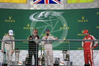 World © Octane Photographic Ltd. Mercedes AMG Petronas F1 W06 Hybrid – Lewis Hamilton, Nico Rosberg and Scuderia Ferrari SF15-T– Sebastian Vettel being interviewed by Sir Elton John. Sunday 25th October 2015, F1 USA Grand Prix Race - Podium, Austin, Texas - Circuit of the Americas (COTA). Digital Ref: 1467LB1D3072