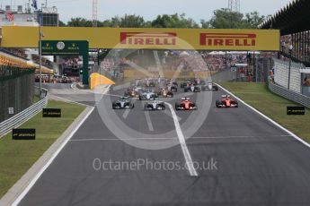 World © Octane Photographic Ltd. Off the line with the Scuderia Ferrari SF15-Ts of Sebastian Vettel and Kimi Raikkonen getting the jump on Mercedes. Sunday 26th July 2015, F1 Hungarian GP Race, Hungaroring, Hungary. Digital Ref: 1360LB1D2427