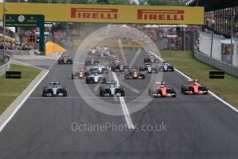 World © Octane Photographic Ltd. Off the line with the Scuderia Ferrari SF15-Ts of Sebastian Vettel and Kimi Raikkonen getting the jump on Mercedes. Sunday 26th July 2015, F1 Hungarian GP Race, Hungaroring, Hungary. Digital Ref: 1360LB1D2436