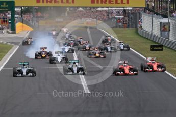 World © Octane Photographic Ltd. Off the line with the Scuderia Ferrari SF15-Ts of Sebastian Vettel and Kimi Raikkonen getting the jump on Mercedes. Sunday 26th July 2015, F1 Hungarian GP Race, Hungaroring, Hungary. Digital Ref: 1360LB1D2440