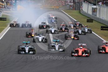 World © Octane Photographic Ltd. The pack enters turn 1 with the Scuderia Ferrari SF15-T of Sebastian Vettel in the lead. Sunday 26th July 2015, F1 Hungarian GP Race, Hungaroring, Hungary. Digital Ref: 1360LB1D2451