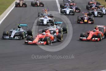 World © Octane Photographic Ltd. The pack enters turn 1 with the Scuderia Ferrari SF15-T of Sebastian Vettel in the lead. Sunday 26th July 2015, F1 Hungarian GP Race, Hungaroring, Hungary. Digital Ref: 1360LB1D2460
