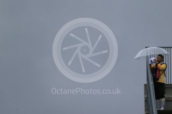 World © Octane Photographic Ltd. Fan with umbrella. Friday 25th September 2015, F1 Japanese Grand Prix, Practice 2, Suzuka. Digital Ref: