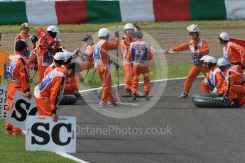 World © Octane Photographic Ltd. Marshals' "tyre change". Saturday 26th September 2015, F1 Japanese Grand Prix, Qualifying, Suzuka. Digital Ref: