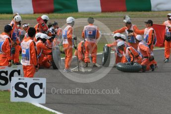 World © Octane Photographic Ltd. Marshals' "tyre change". Saturday 26th September 2015, F1 Japanese Grand Prix, Qualifying, Suzuka. Digital Ref: