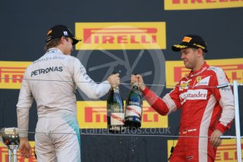 World © Octane Photographic Ltd. Mercedes AMG Petronas F1 W06 Hybrid – Nico Rosberg (2nd) and Scuderia Ferrari SF15-T– Sebastian Vettel (3rd). Sunday 27th September 2015, F1 Japanese Grand Prix, Podium, Suzuka. Digital Ref: