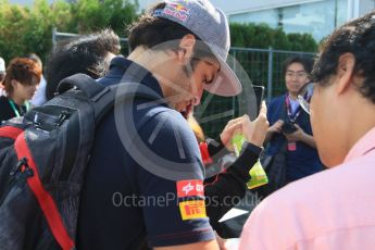 World © Octane Photographic Ltd. Scuderia Toro Rosso STR10 – Carlos Sainz Jnr sign autographs for the fans. Saturday 26th September 2015, F1 Japanese Grand Prix, Paddock, Suzuka. Digital Ref: 1445CB7D6280