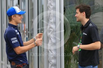 World © Octane Photographic Ltd. Sauber F1 Team C34-Ferrari – Marcus Ericsson and Lotus F1 Team Reserve Driver – Jolyon Palmer discussing Marcus' big slide yesterday. Sunday 27th September 2015, F1 Japanese Grand Prix, Setup, Suzuka. Digital Ref: 1448CB7D7883