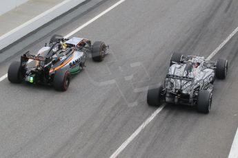 World © Octane Photographic Ltd. Sahara Force India VJM07 – Pascal Wehrlein passes the Infiniti Red Bull Racing RB11 – Daniil Kvyat at the pit exit. Saturday 21st February 2015, F1 Winter testing, Circuit de Barcelona Catalunya, Spain, Day 3. Digital Ref :1190CB1L6988