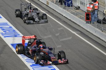 World © Octane Photographic Ltd. Scuderia Toro Rosso STR10 – Max Verstappen and Infiniti Red Bull Racing RB11 – Daniil Kvyat released at the same time into the pitlane. Saturday 21st February 2015, F1 Winter testing, Circuit de Barcelona Catalunya, Spain, Day 3. Digital Ref: 1190CB1L8610