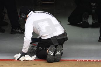 World © Octane Photographic Ltd. McLaren Honda mechanic cleaning the pit floor. Thursday 26th February 2015, F1 Winter test #3, Circuit de Barcelona-Catalunya, Spain Test 2 Day 1. Digital Ref: 1192CB7B0981