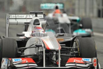 World © Octane Photographic 2011. Formula 1 testing Friday 11th March 2011 Circuit de Catalunya. Sauber C30 - Kamui Kobayashi. Mercedes MGP W02 - Michael Schumacher. Digital ref : 0022CB1D3855
