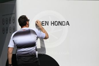 World © Octane Photographic Ltd. McLaren Honda team member re-applying the paddock name stickers. Thursday 24th November 2016, F1 Abu Dhabi GP - Paddock, Yas Marina circuit, Abu Dhabi. Digital Ref :