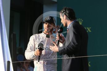 World © Octane Photographic Ltd. Mercedes AMG Petronas – Lewis Hamilton and Mark Webber. Sunday 20th March 2016, F1 Australian GP Race - Podium, Melbourne, Albert Park, Australia. Digital Ref : 1525LB1D8253