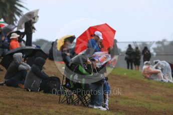 World © Octane Photographic Ltd. Fans watch in the rain. Friday 18th March 2016, F1 Australian GP Practice 1, Melbourne, Albert Park, Australia. Digital Ref : 1516LB5D1250