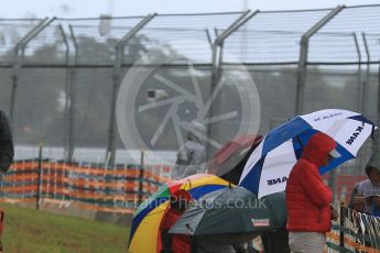 World © Octane Photographic Ltd. Fans watch in the rain. Friday 18th March 2016, F1 Australian GP Practice 1, Melbourne, Albert Park, Australia. Digital Ref : 1516LB5D1254