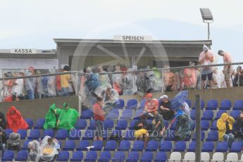 World © Octane Photographic Ltd. Fans in the grandstands during the thunderstorm. Friday 1st July 2016, F1 Austrian GP Practice 2, Red Bull Ring, Spielberg, Austria. Digital Ref : 1600CB1D2500