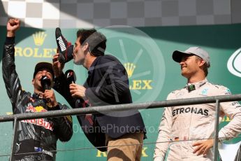 World © Octane Photographic Ltd. Red Bull Racing – Daniel Ricciardo offers champagne from his race boot to Mark Webber. Sunday 28th August 2016, F1 Belgian GP Race Podium, Spa-Francorchamps, Belgium. Digital Ref : 1693LB1D3408