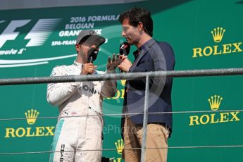 World © Octane Photographic Ltd. Mercedes AMG Petronas – Lewis Hamilton and Mark Webber. Sunday 28th August 2016, F1 Belgian GP Race Podium, Spa-Francorchamps, Belgium. Digital Ref : 1693LB1D3495