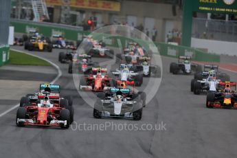 World © Octane Photographic Ltd. Scuderia Ferrari SF16-H – Sebastian Vettel ahead of Mercedes AMG Petronas W07 Hybrid – Nico Rosberg and Lewis Hamilton. Sunday 12th June 2016, F1 Canadian GP Race, Circuit Gilles Villeneuve, Montreal, Canada. Digital Ref :1592LB1D3419