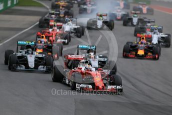 World © Octane Photographic Ltd. Scuderia Ferrari SF16-H – Sebastian Vettel ahead of Mercedes AMG Petronas W07 Hybrid – Nico Rosberg and Lewis Hamilton. Sunday 12th June 2016, F1 Canadian GP Race, Circuit Gilles Villeneuve, Montreal, Canada. Digital Ref :1592LB1D3428