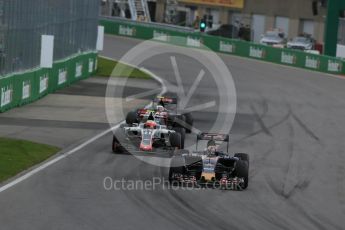 World © Octane Photographic Ltd. Haas F1 Team VF-16 – Romain Grosjean dicing with Scuderia Toro Rosso STR11 – Daniil Kvyat and Carlos Sainz. Sunday 12th June 2016, F1 Canadian GP Race, Circuit Gilles Villeneuve, Montreal, Canada. Digital Ref :1592LB1D3974