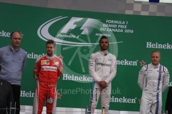 World © Octane Photographic Ltd. Mercedes AMG Petronas – Lewis Hamilton (1st), Scuderia Ferrari – Sebastian Vettel (2nd) and Williams Martini Racing, – Valtteri Bottas (3rd) with Mercedes AMG Petronas Head of Electronics – Evan Short (Constructors’ Trophy). Sunday 12th June 2016, F1 Canadian GP Podium, Circuit Gilles Villeneuve, Montreal, Canada. Digital Ref :1593LB1D4440