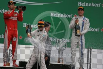 World © Octane Photographic Ltd. Mercedes AMG Petronas – Lewis Hamilton (1st), Scuderia Ferrari – Sebastian Vettel (2nd) and Williams Martini Racing, – Valtteri Bottas (3rd). Sunday 12th June 2016, F1 Canadian GP Podium, Circuit Gilles Villeneuve, Montreal, Canada. Digital Ref :1593LB1D4634